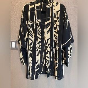 Women’s share black and yellow jacket with cape back. Dress up or dress down.